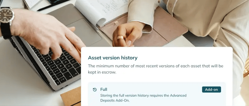 Two people discussing with an app snippet showing asset version history at the lower right.
