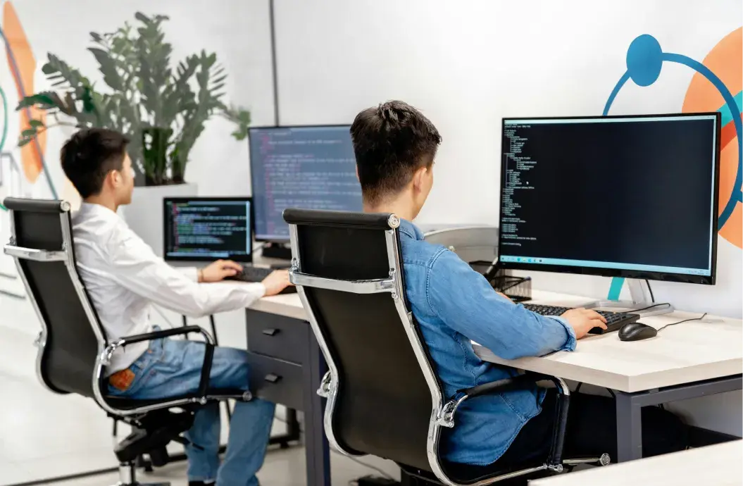 Two developers sitting and working together.